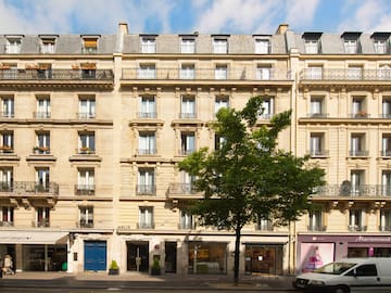 a building with many windows and a tree