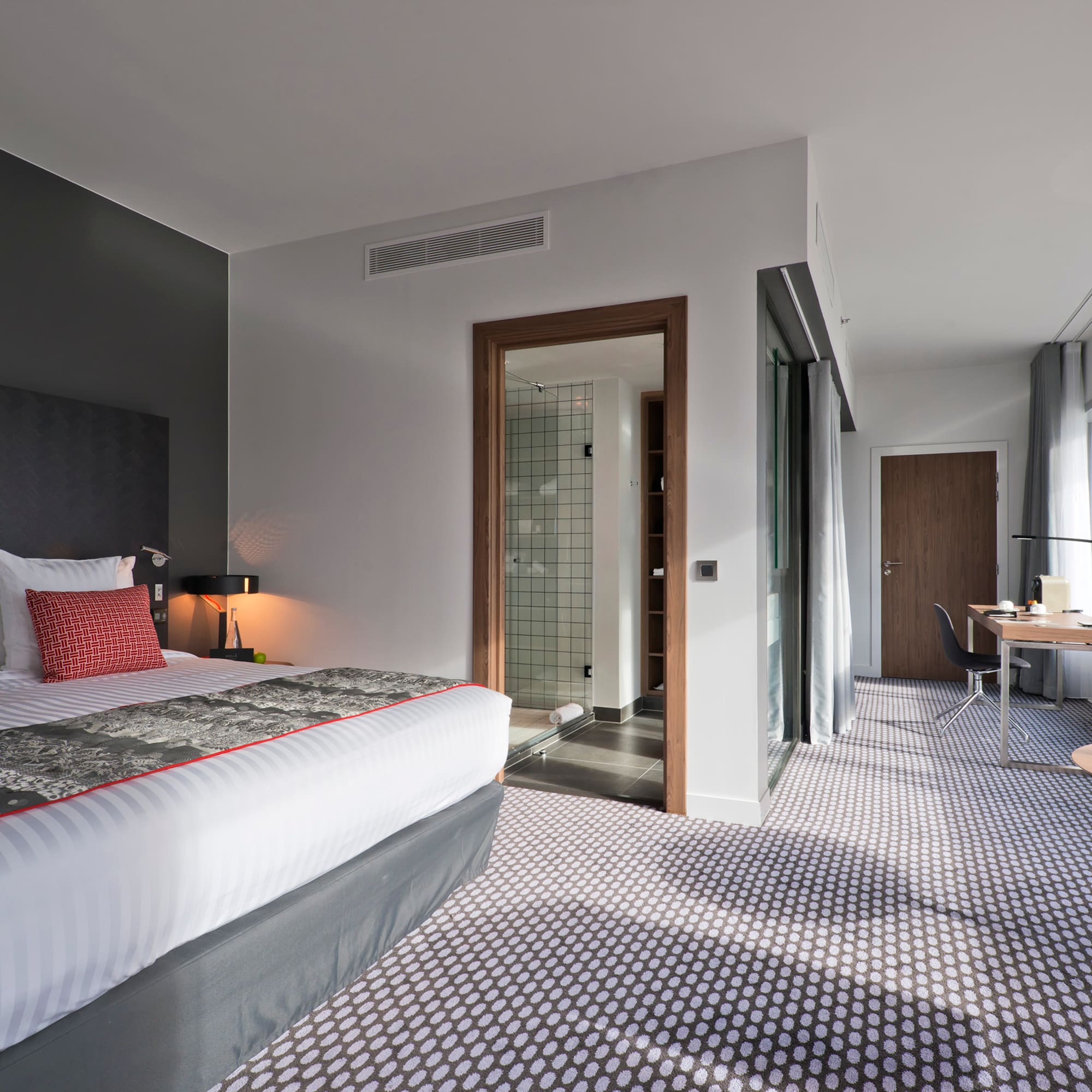 a bedroom with a bed and a desk