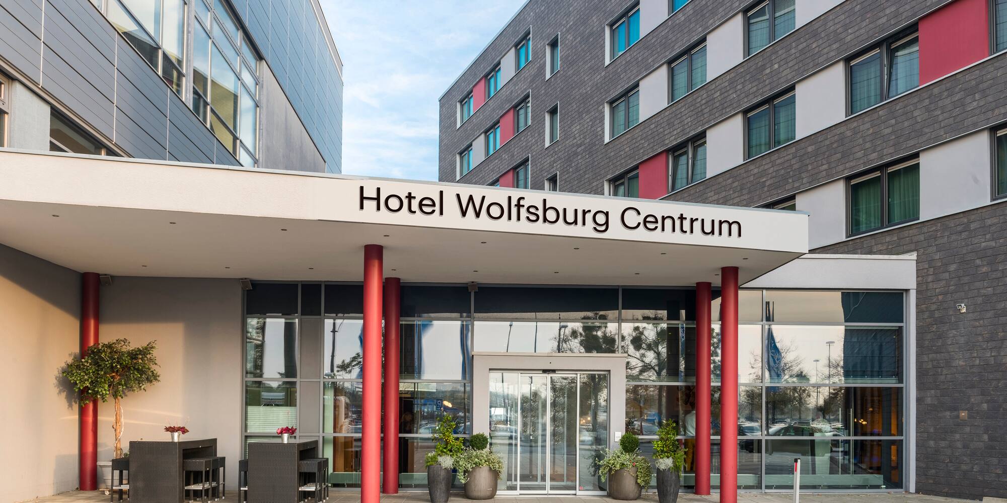 a building with red pillars and a sign