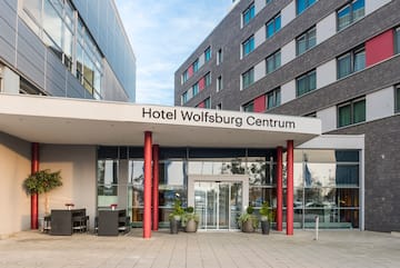 a building with red pillars and a sign