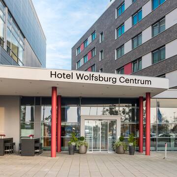 a building with red pillars and a sign