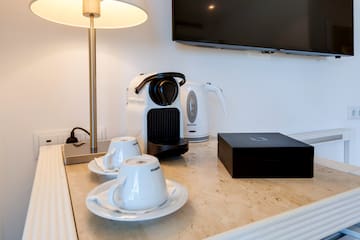 a coffee machine and tea cups on a counter