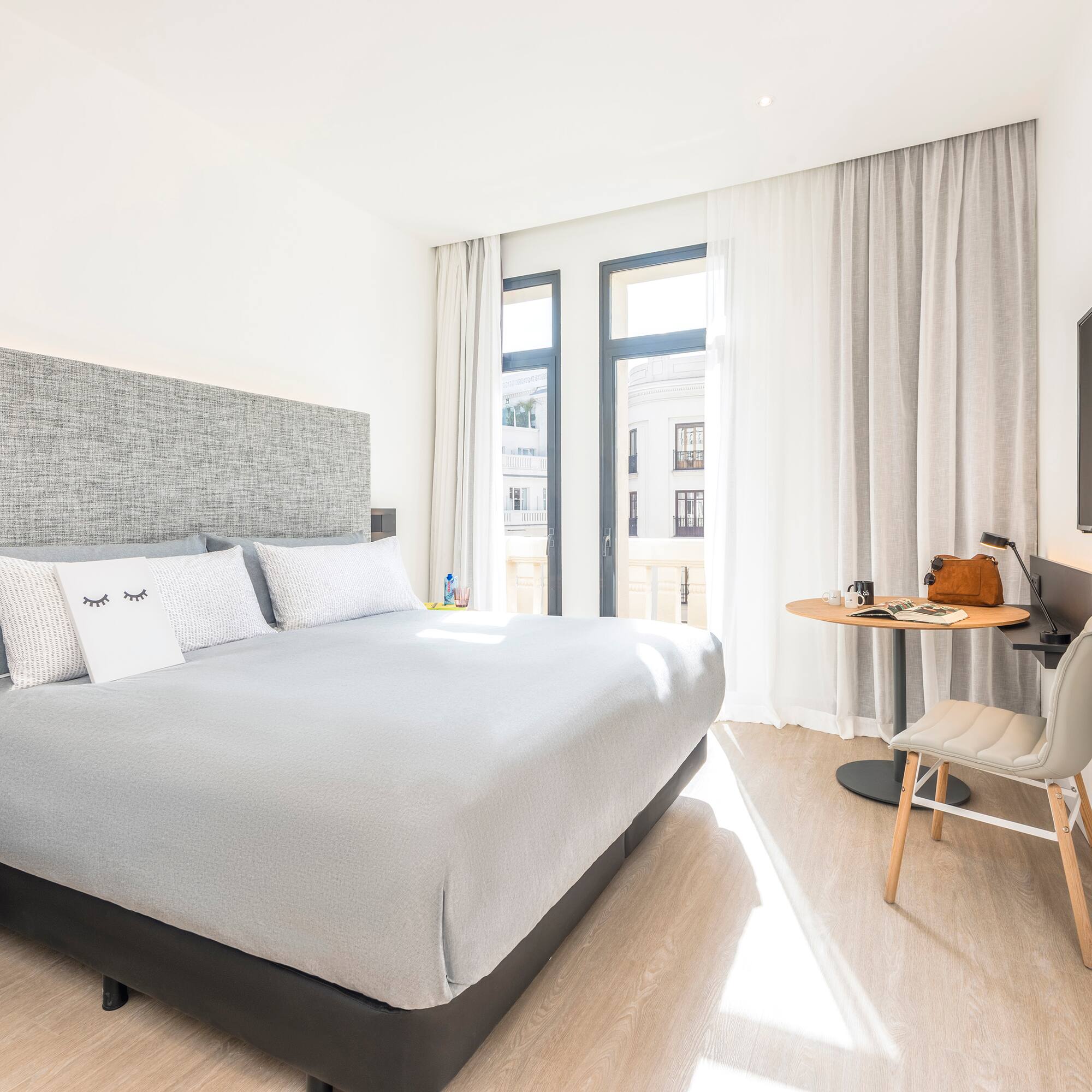 a bedroom with a bed and a desk