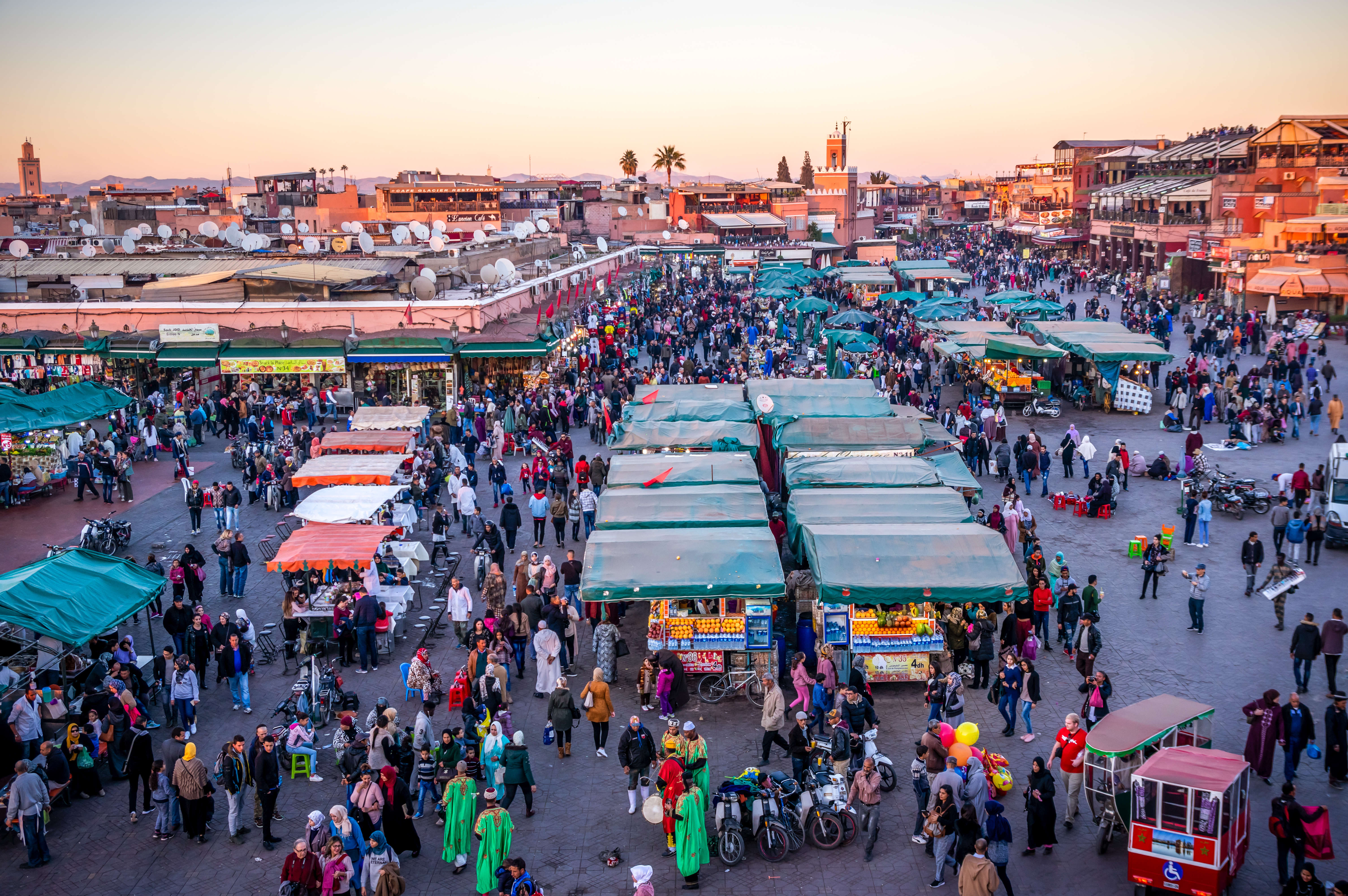 a crowd of people in a street market