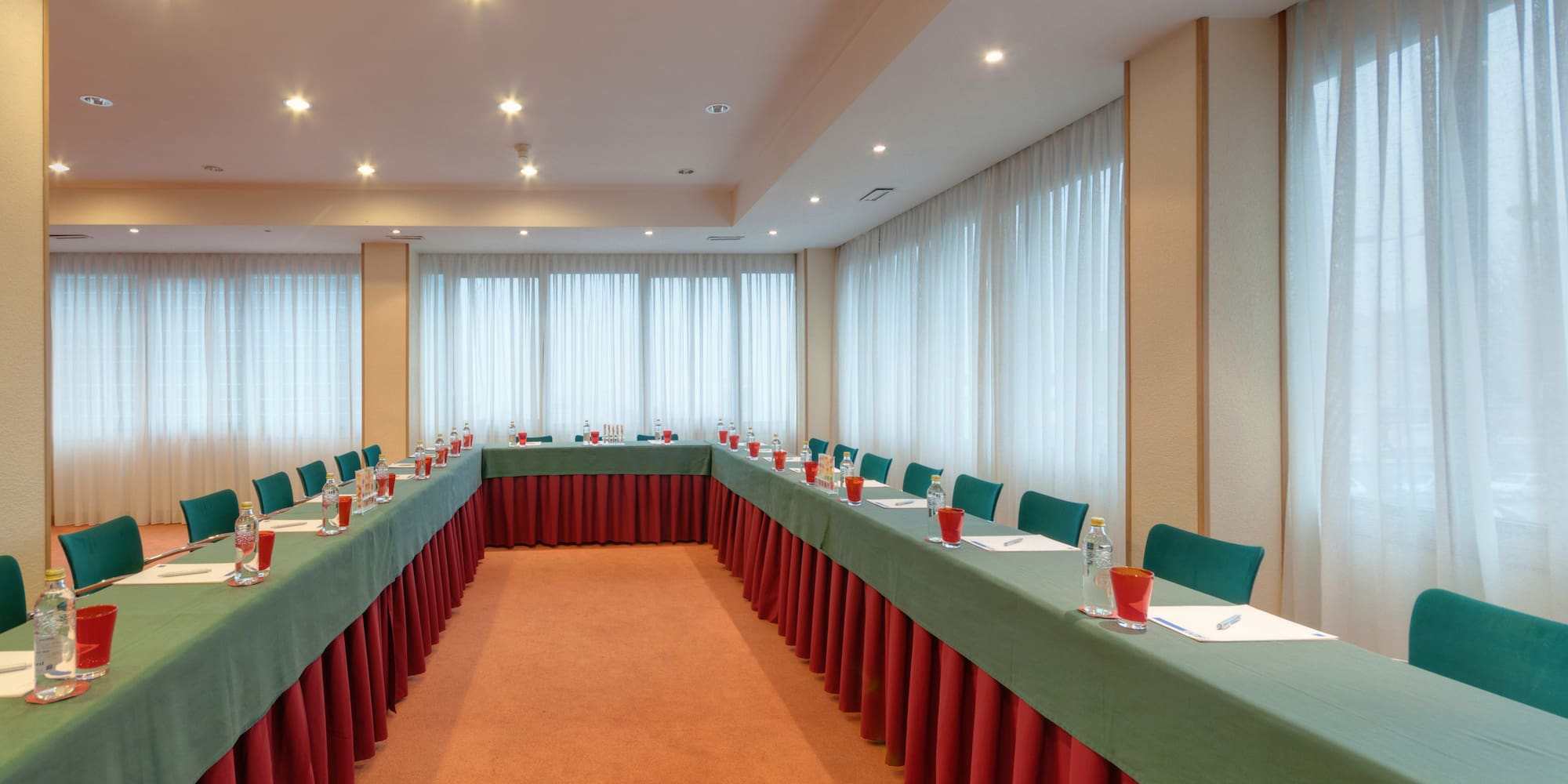 a room with long tables and chairs