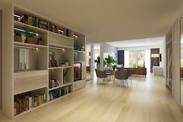 a room with a dining table and bookshelves