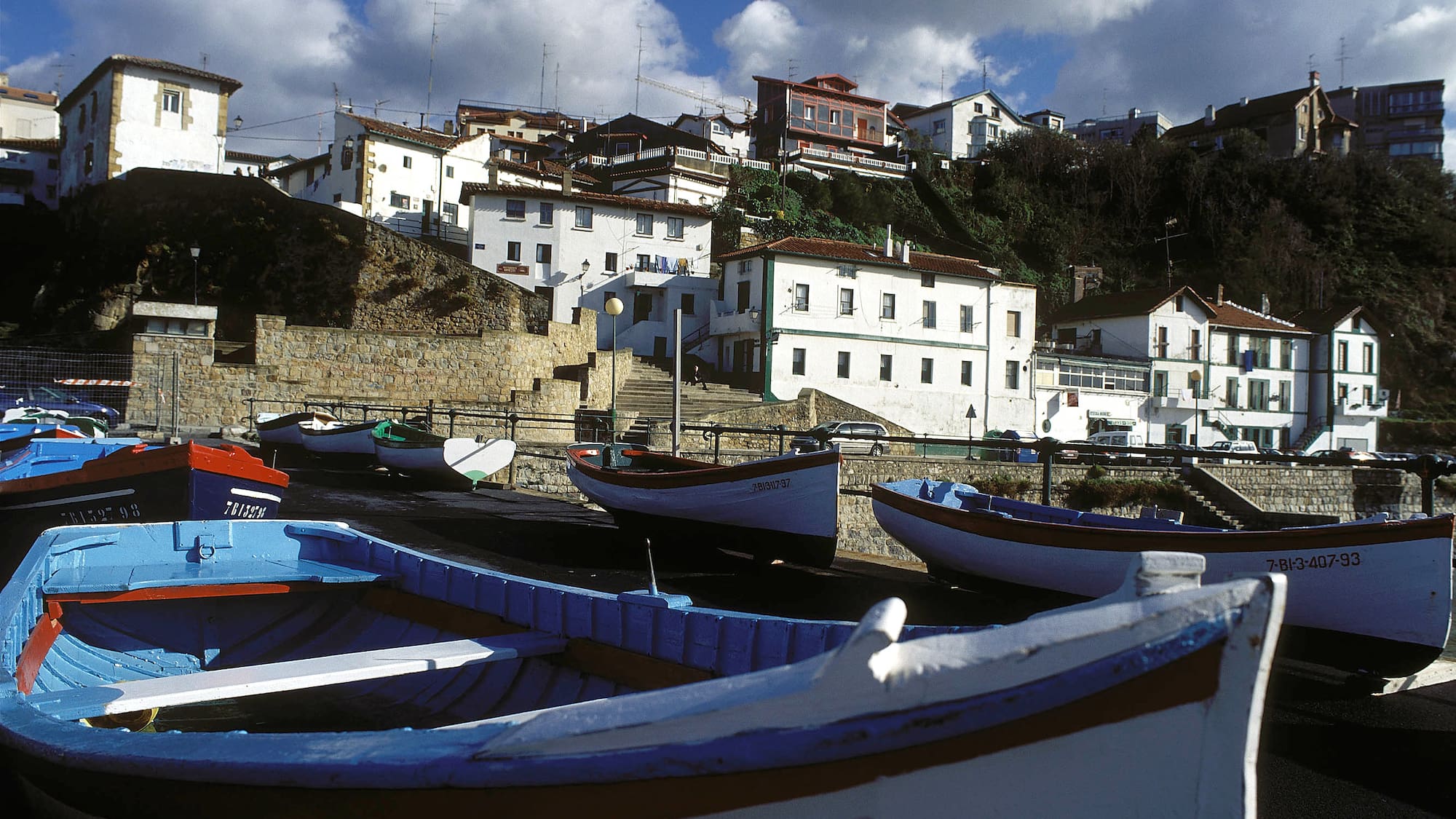 boats on the shore of a town