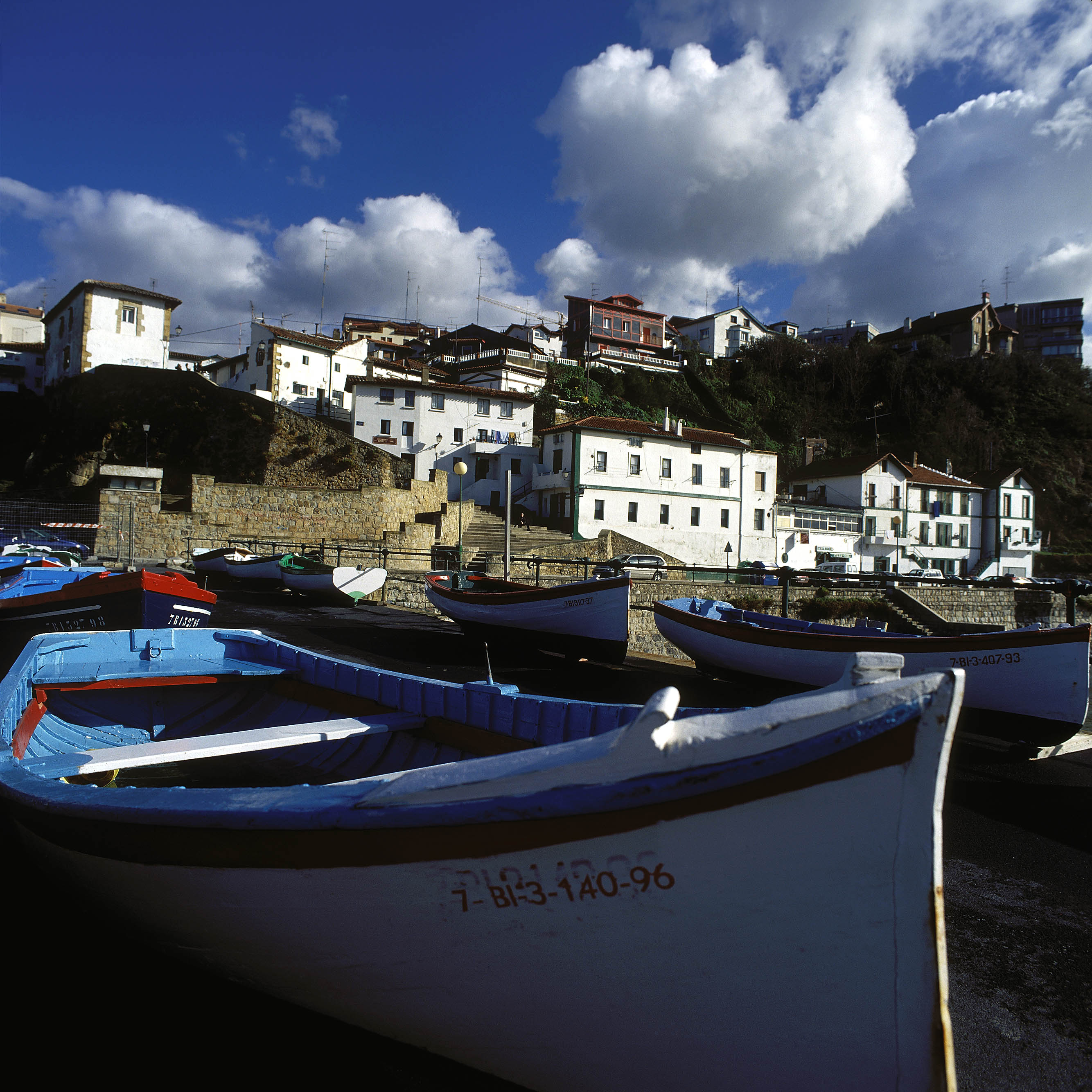 boats on the shore of a town
