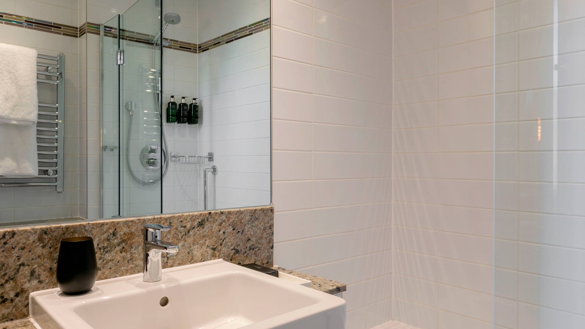 a bathroom with a shower and sink