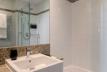 a bathroom with a shower and sink