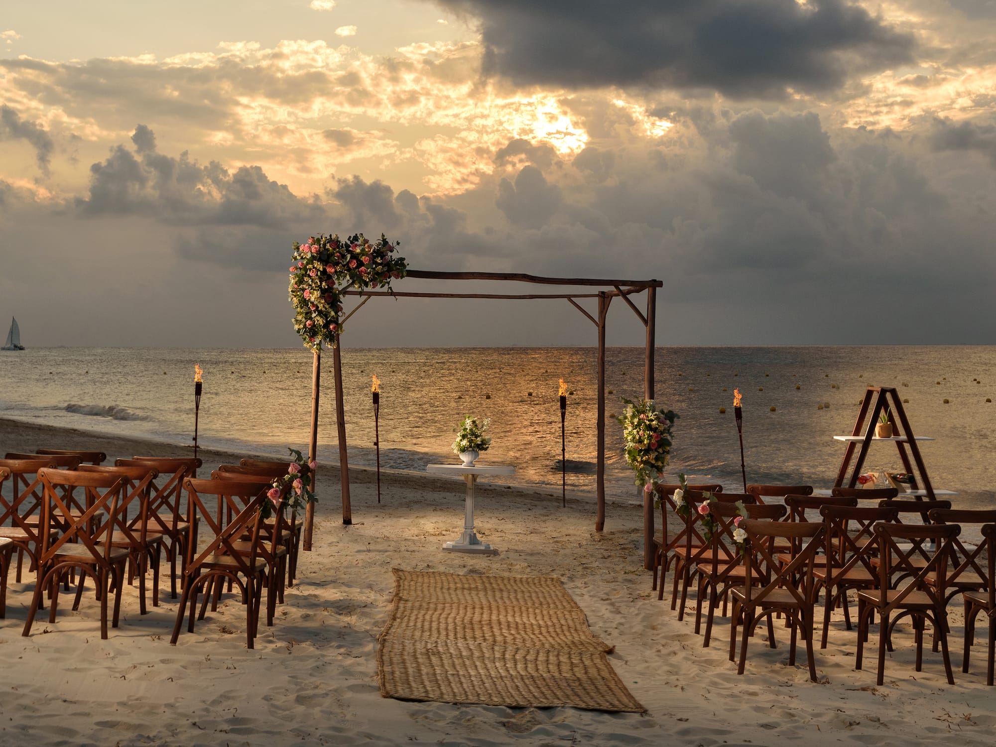 a beach setting with chairs and flowers