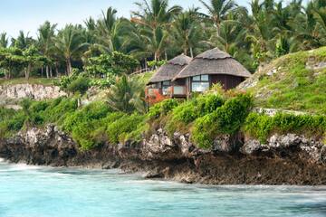 a house on a cliff by the water