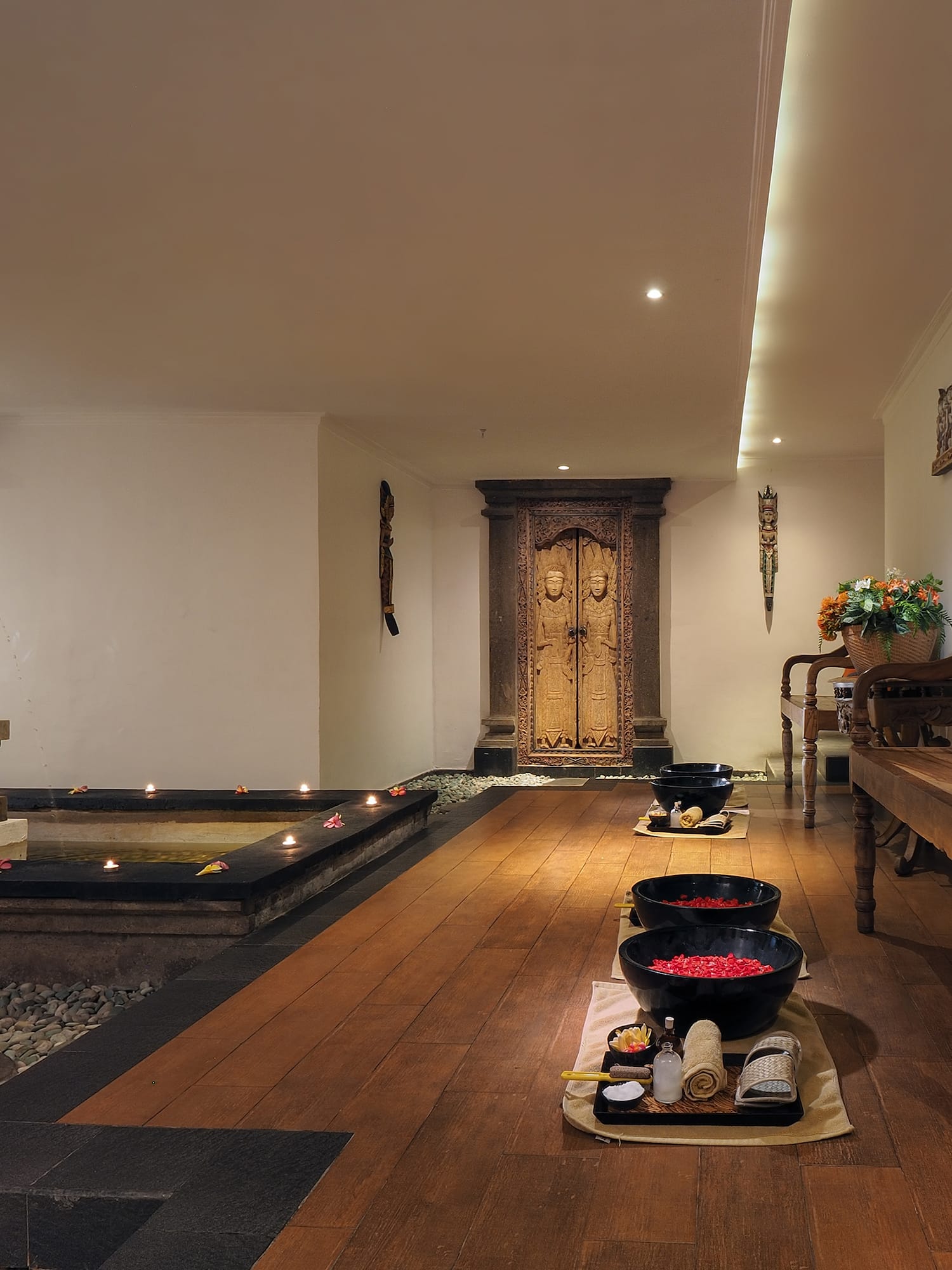 a room with a wood floor and a bench and a fountain