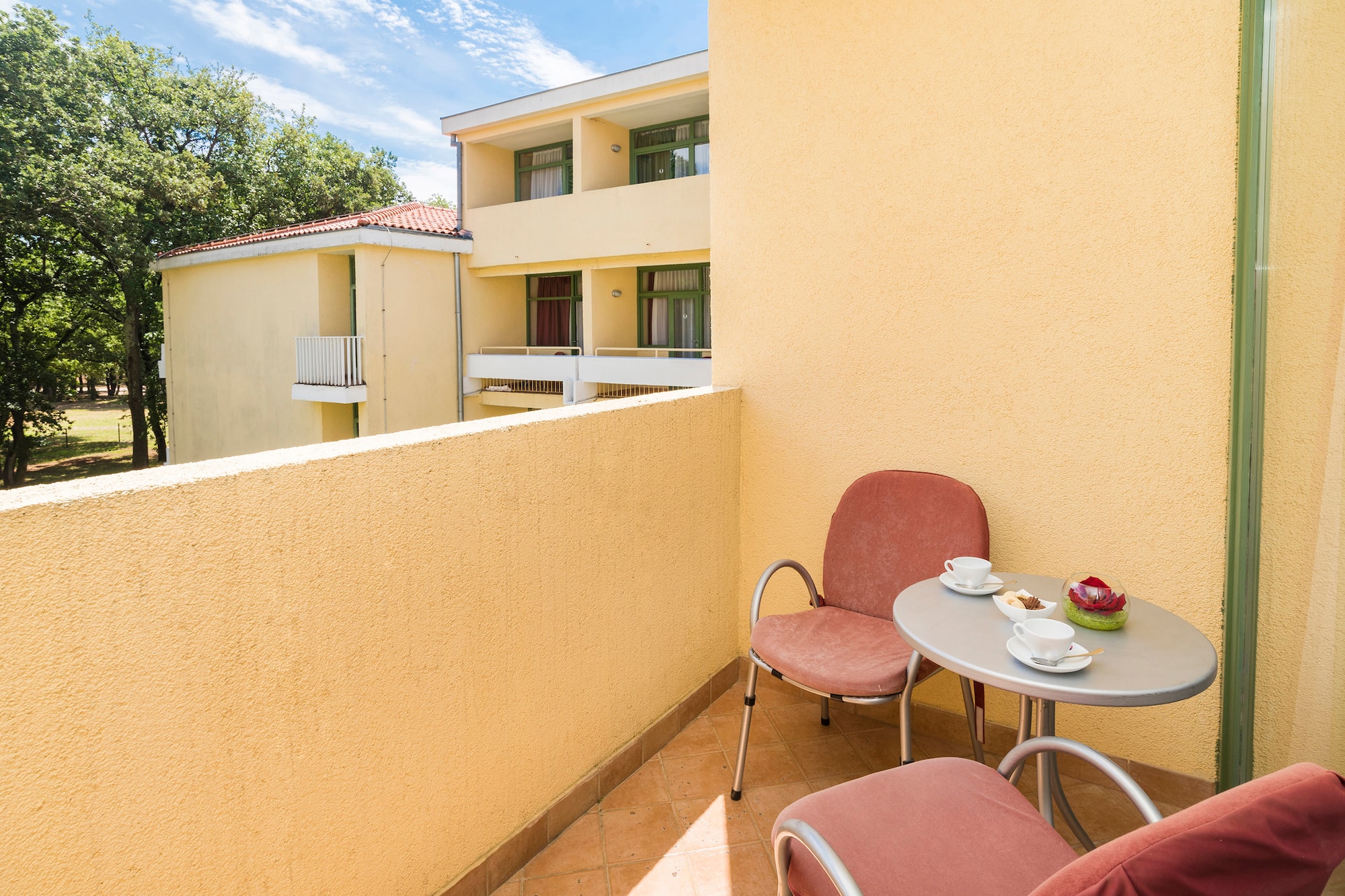 a table and chairs on a balcony