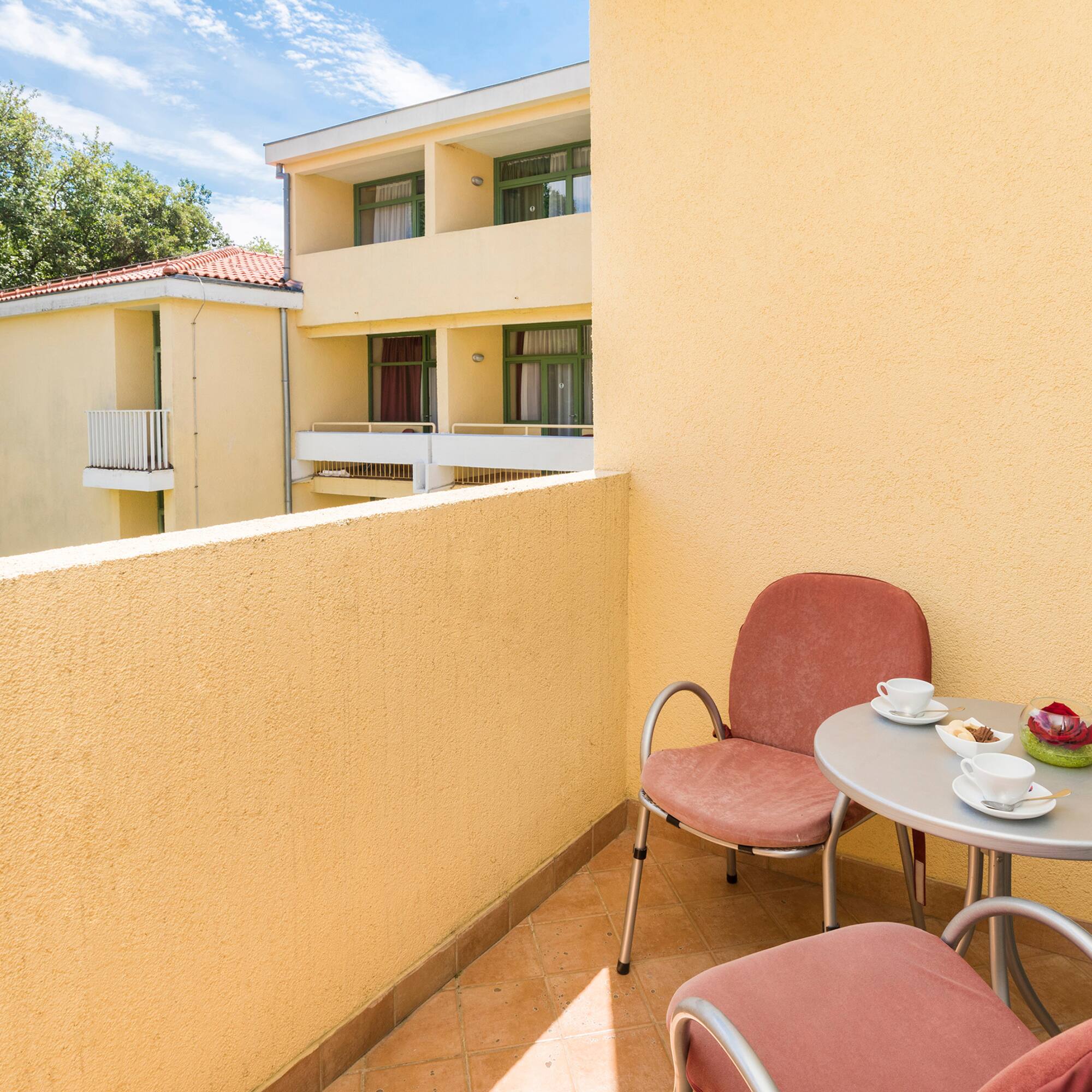 a table and chairs on a balcony