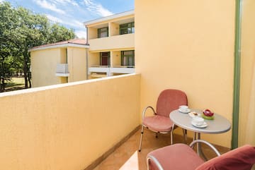 a table and chairs on a balcony