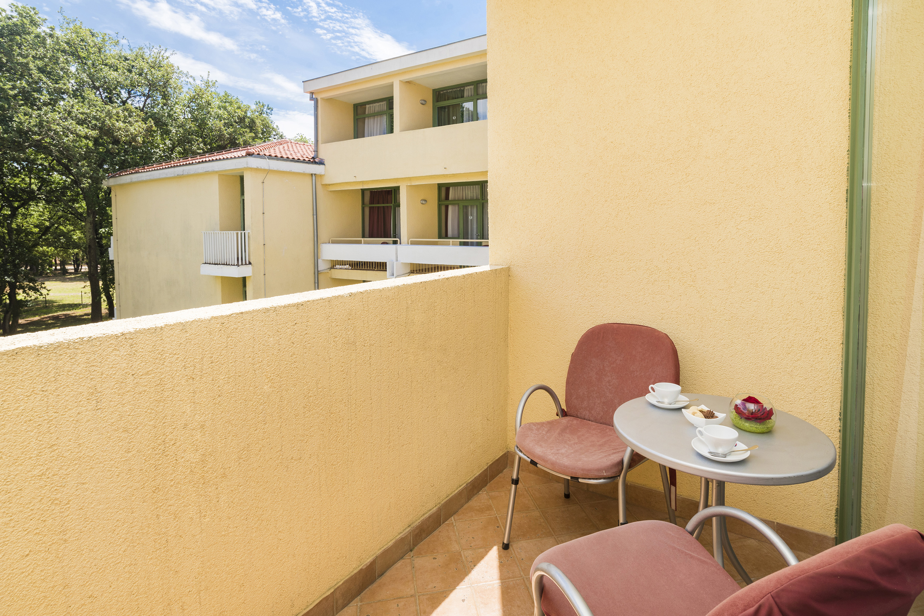 a table and chairs on a balcony