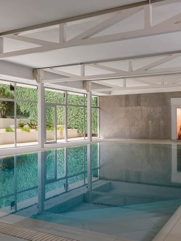 a indoor pool with windows