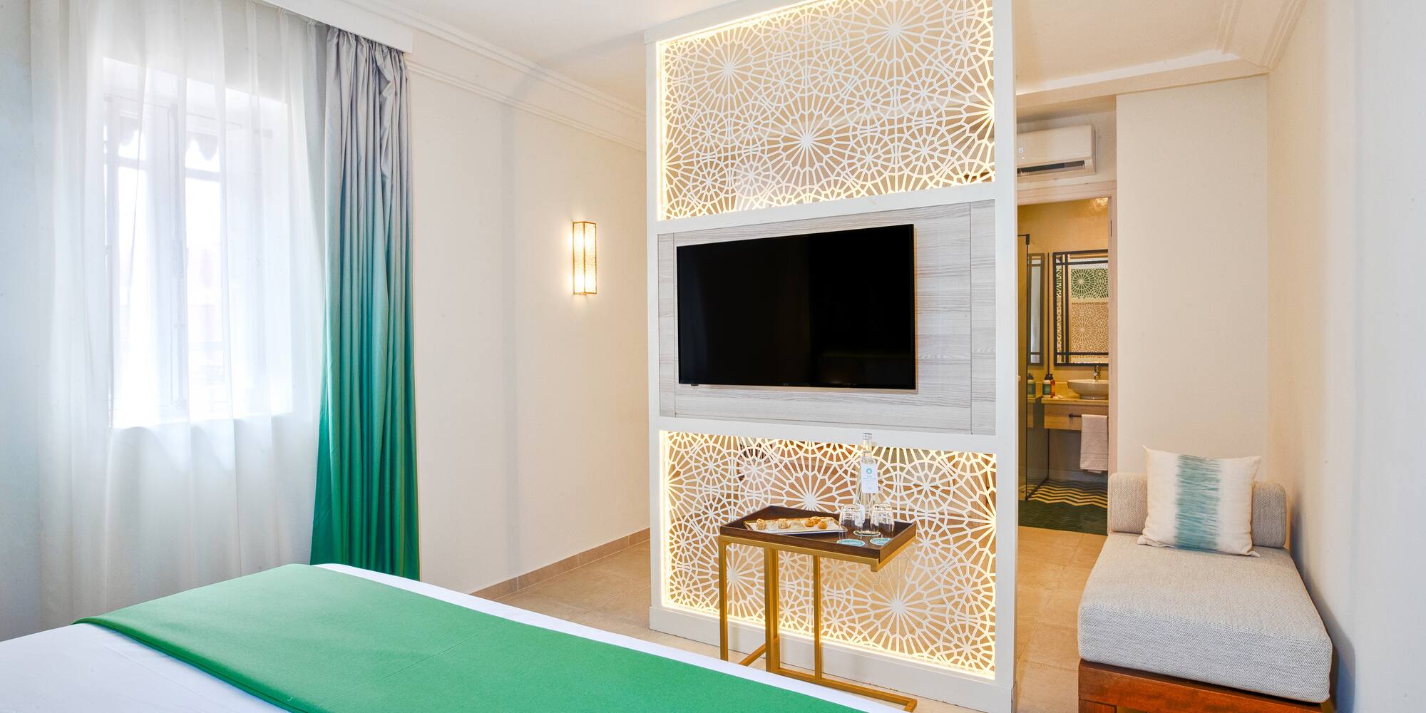 a room with a bed and a tv