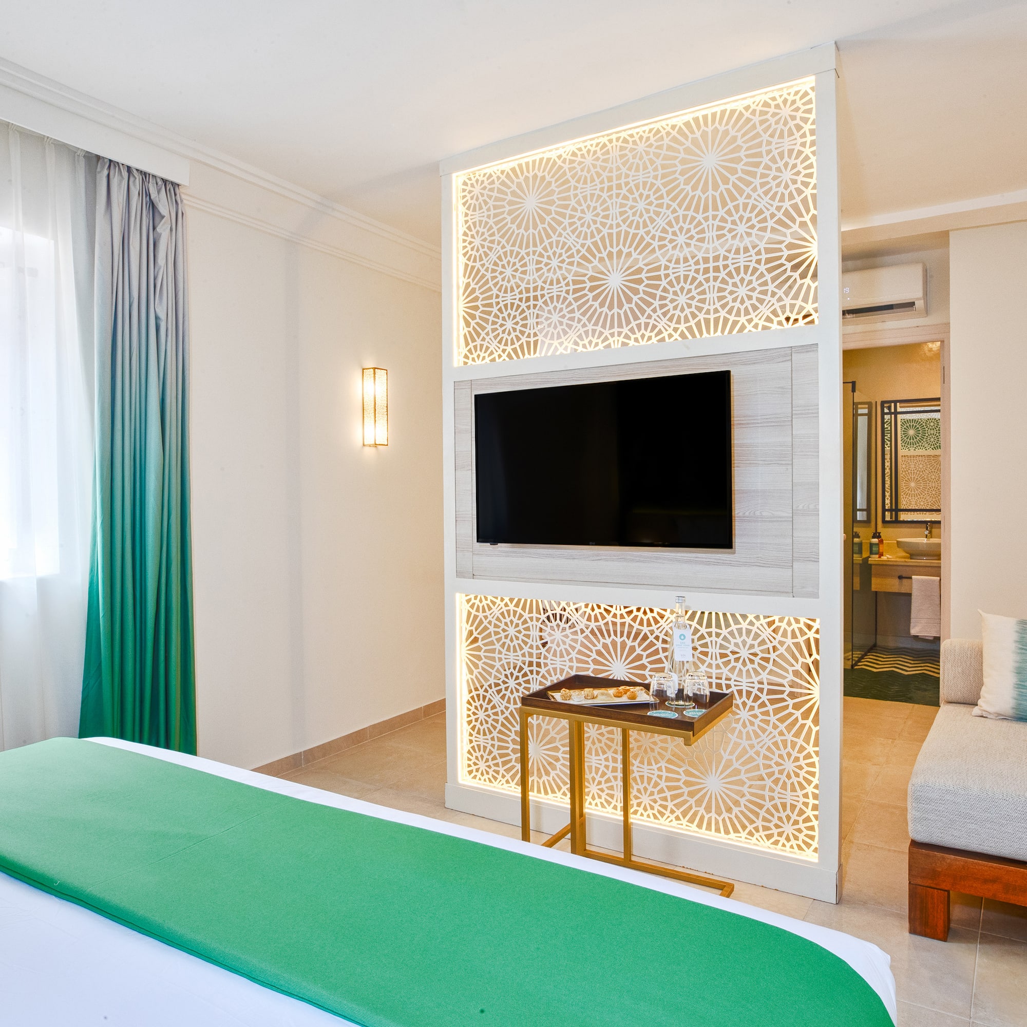 a room with a bed and a tv