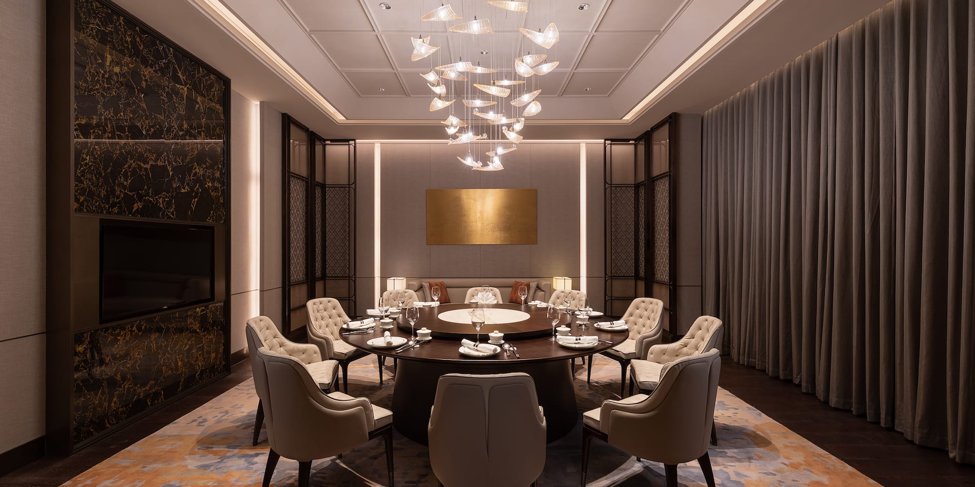 a room with a round table and chairs