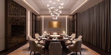 a room with a round table and chairs