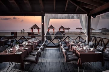 a restaurant with tables and chairs on a beach