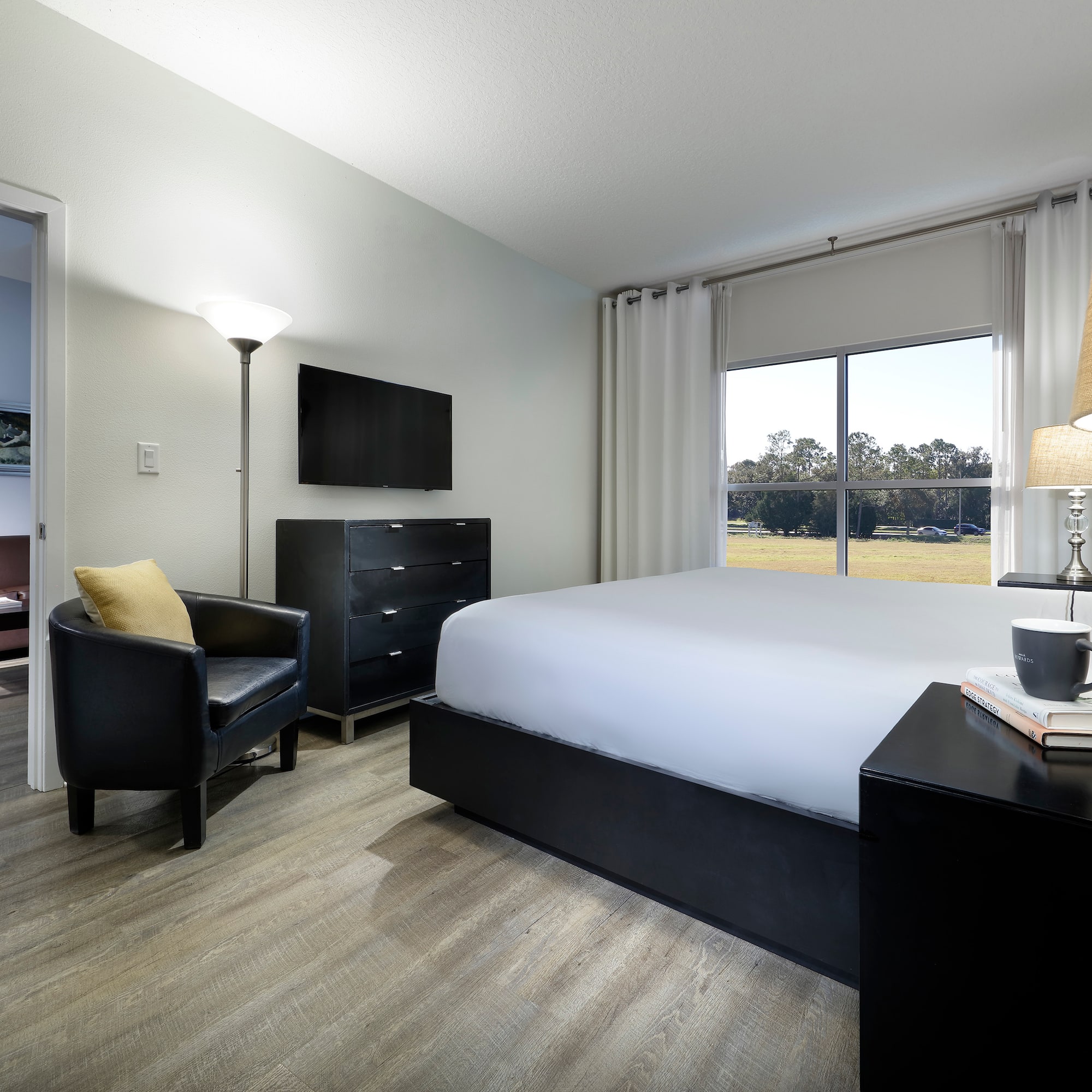 a bedroom with a bed and a chair