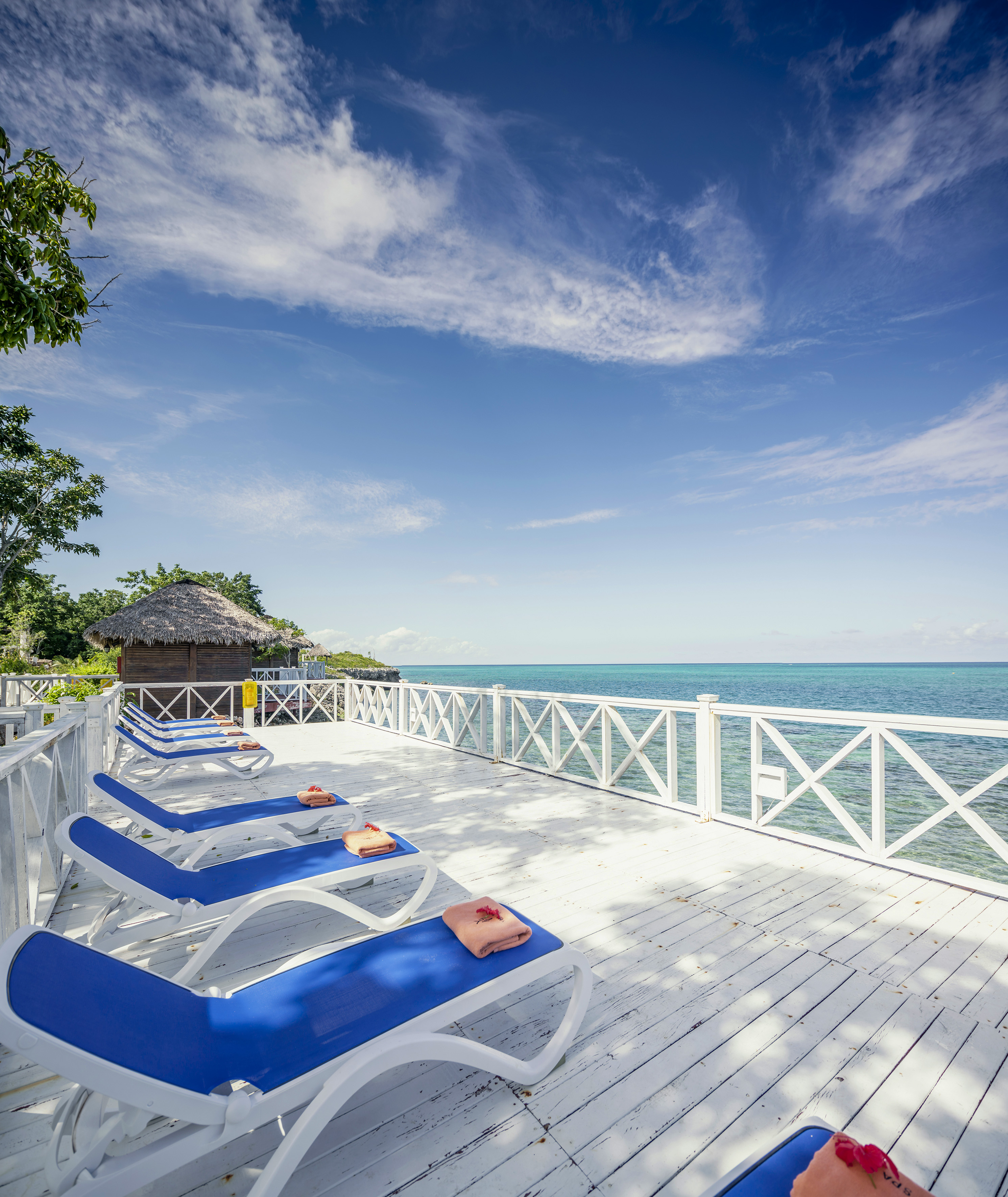 a deck with chairs and a body of water