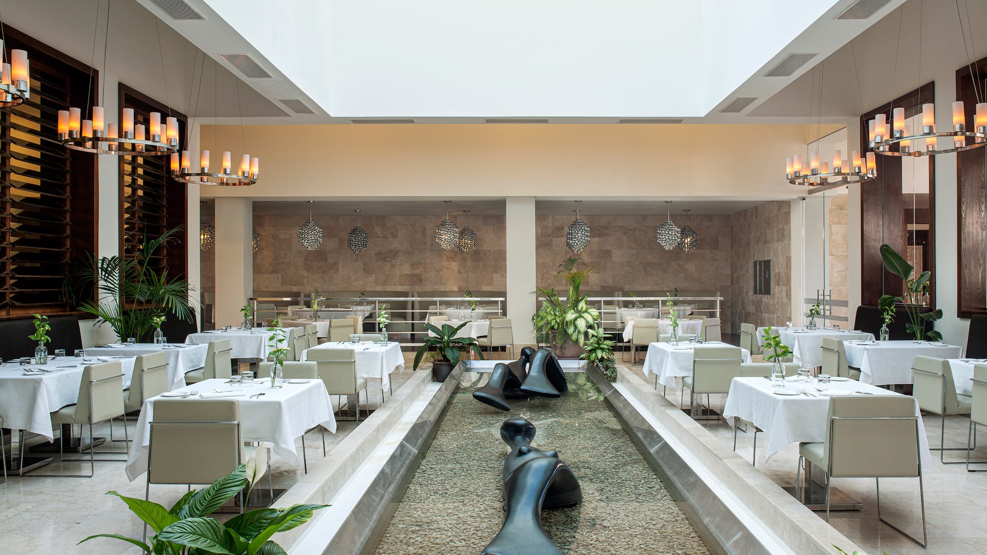 a room with tables and chairs and a fountain