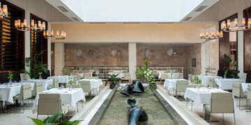 a room with tables and chairs and a fountain