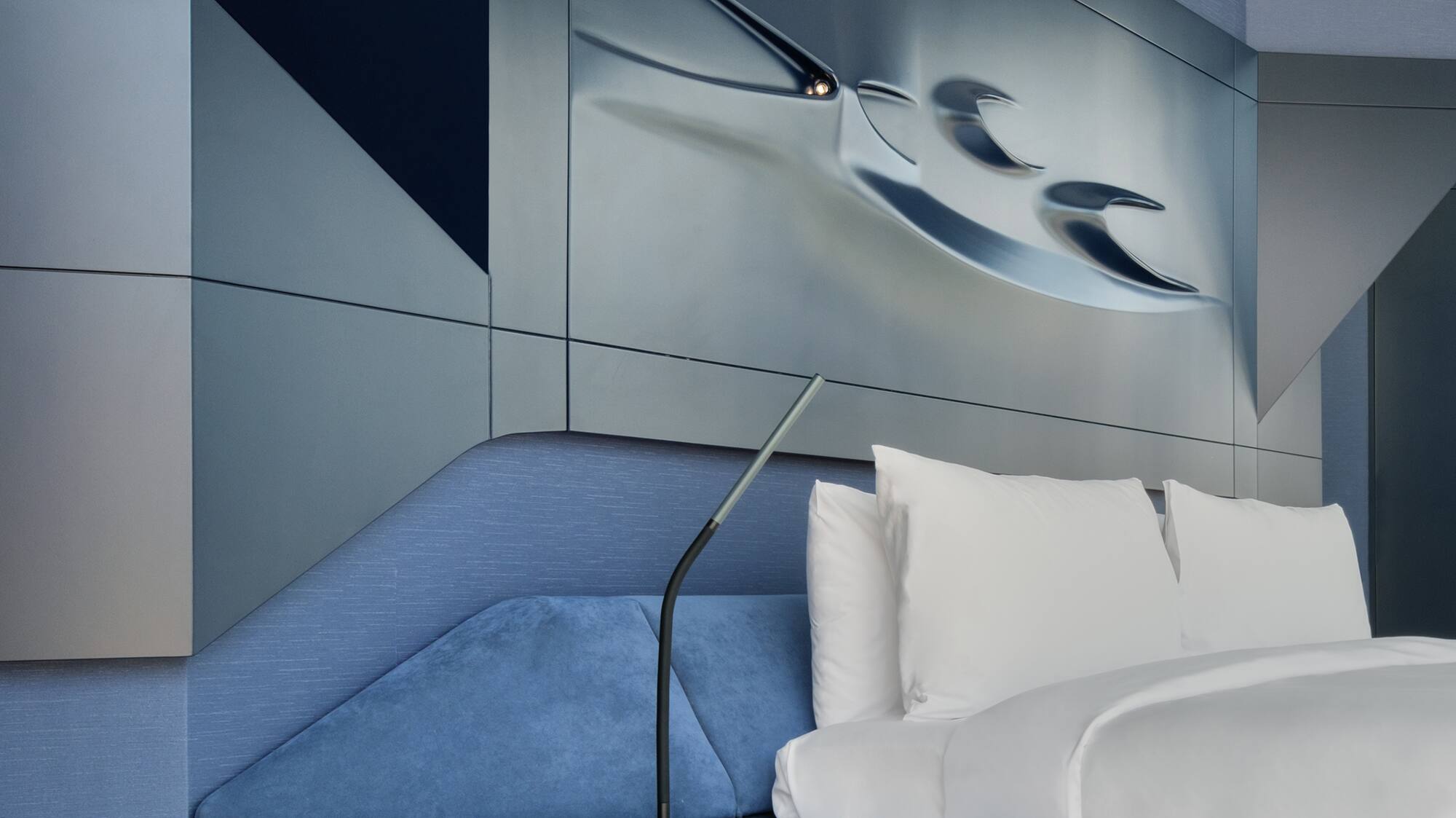 a bed with a lamp on the side