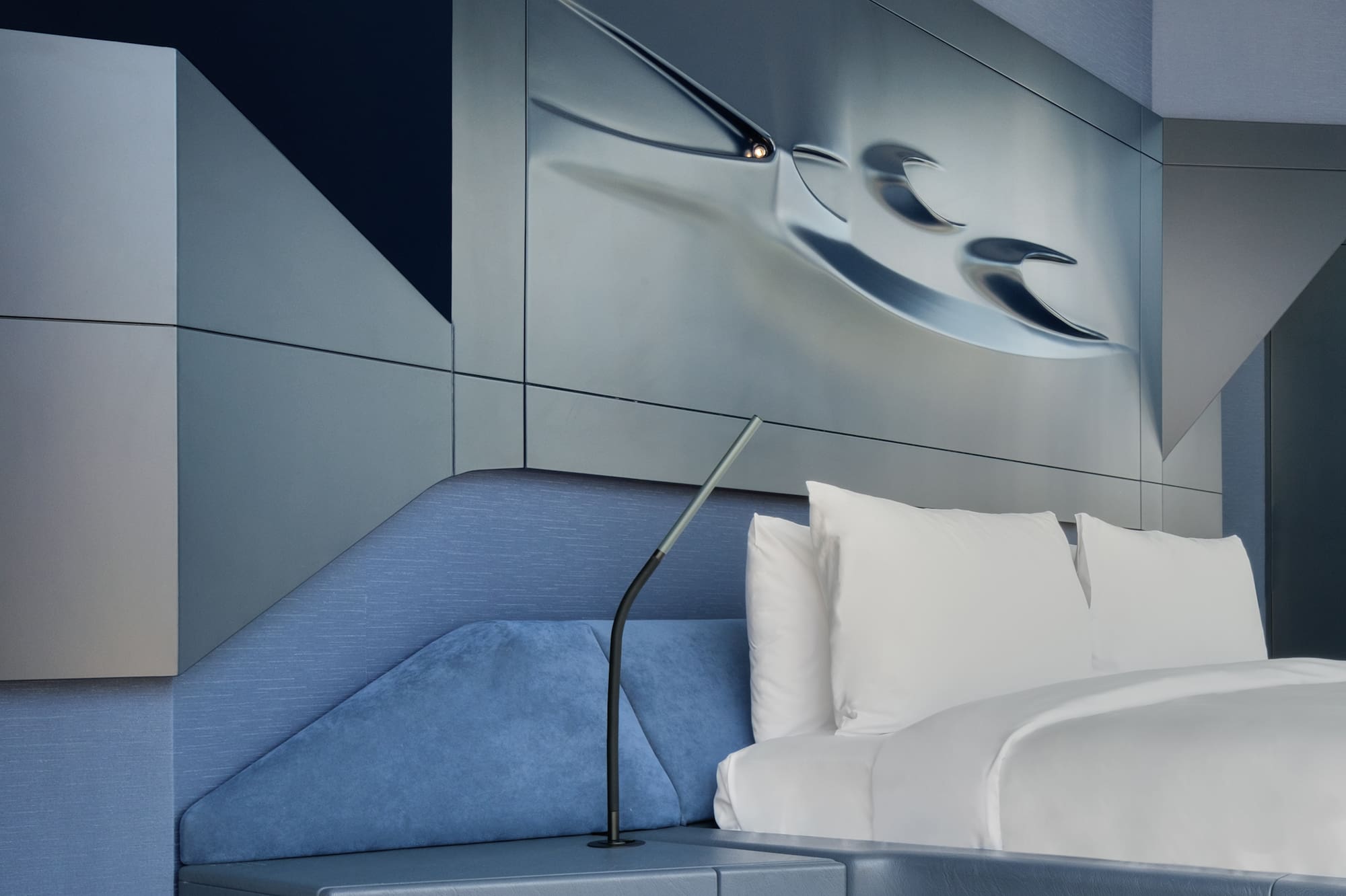 a bed with a lamp on the side