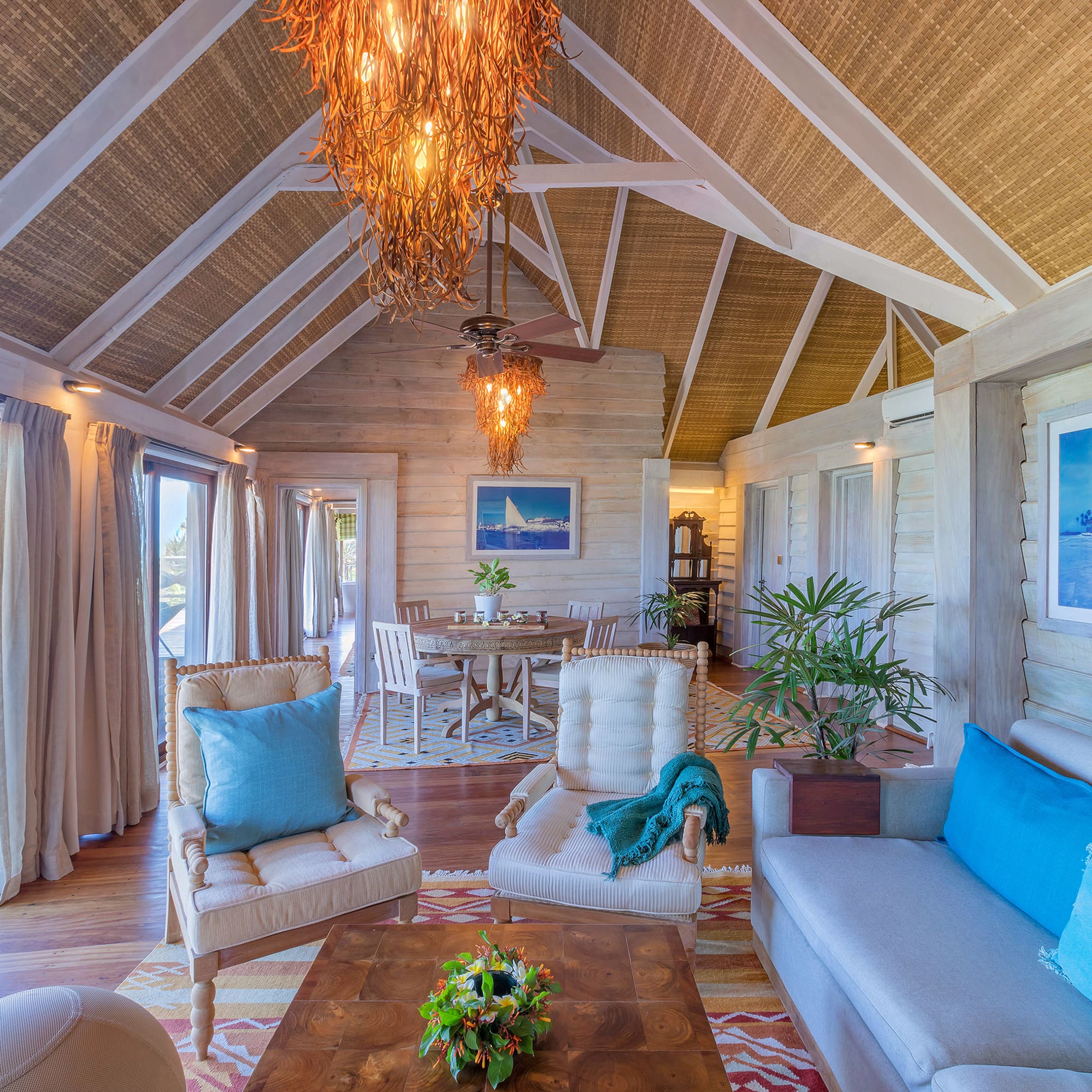 a living room with a table and chairs