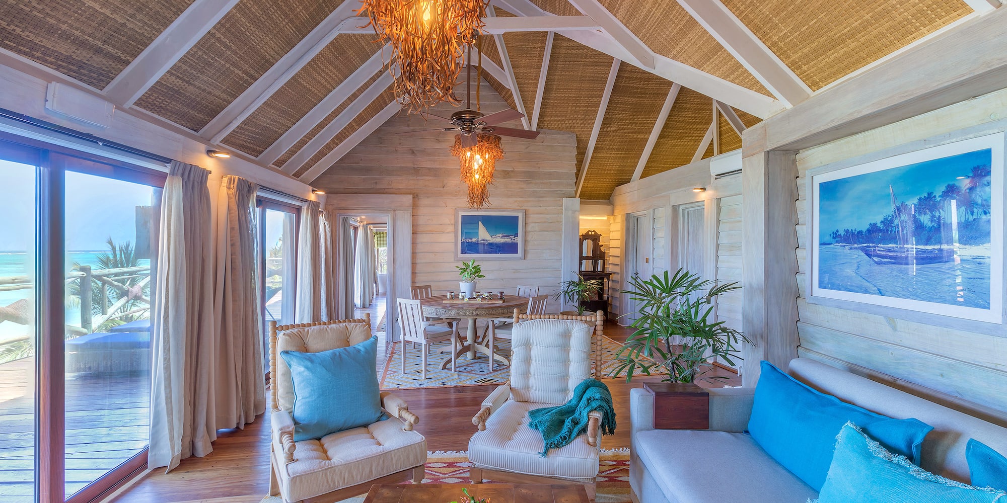a living room with a table and chairs