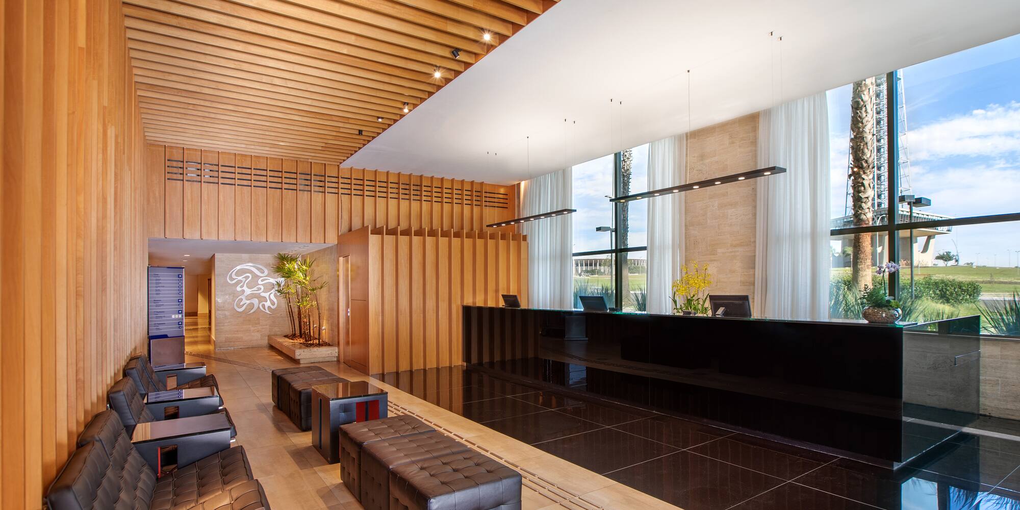 a lobby with a black counter and chairs