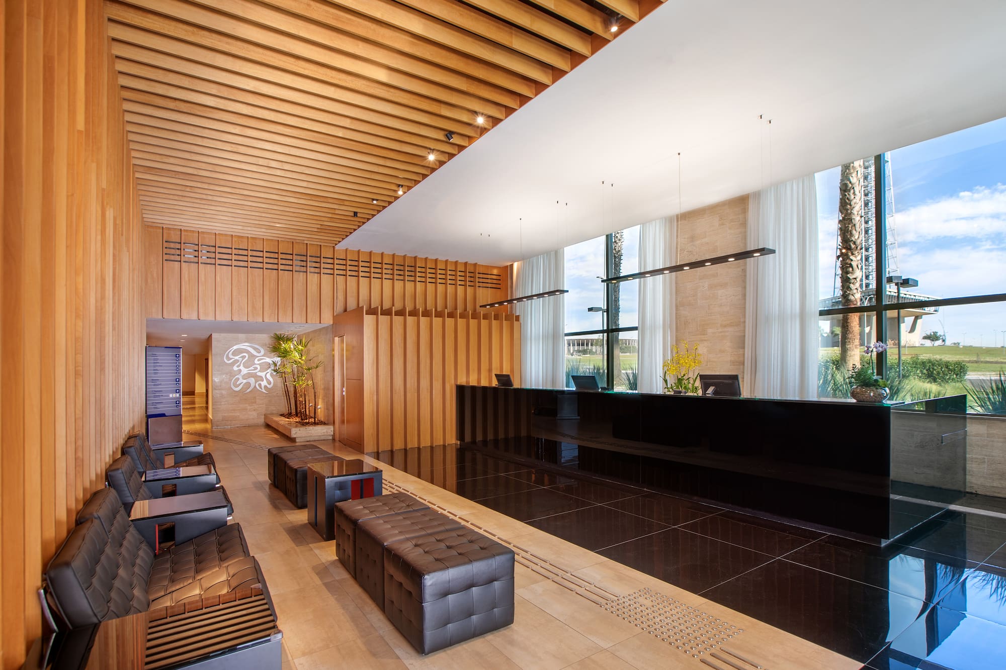 a lobby with a black counter and chairs
