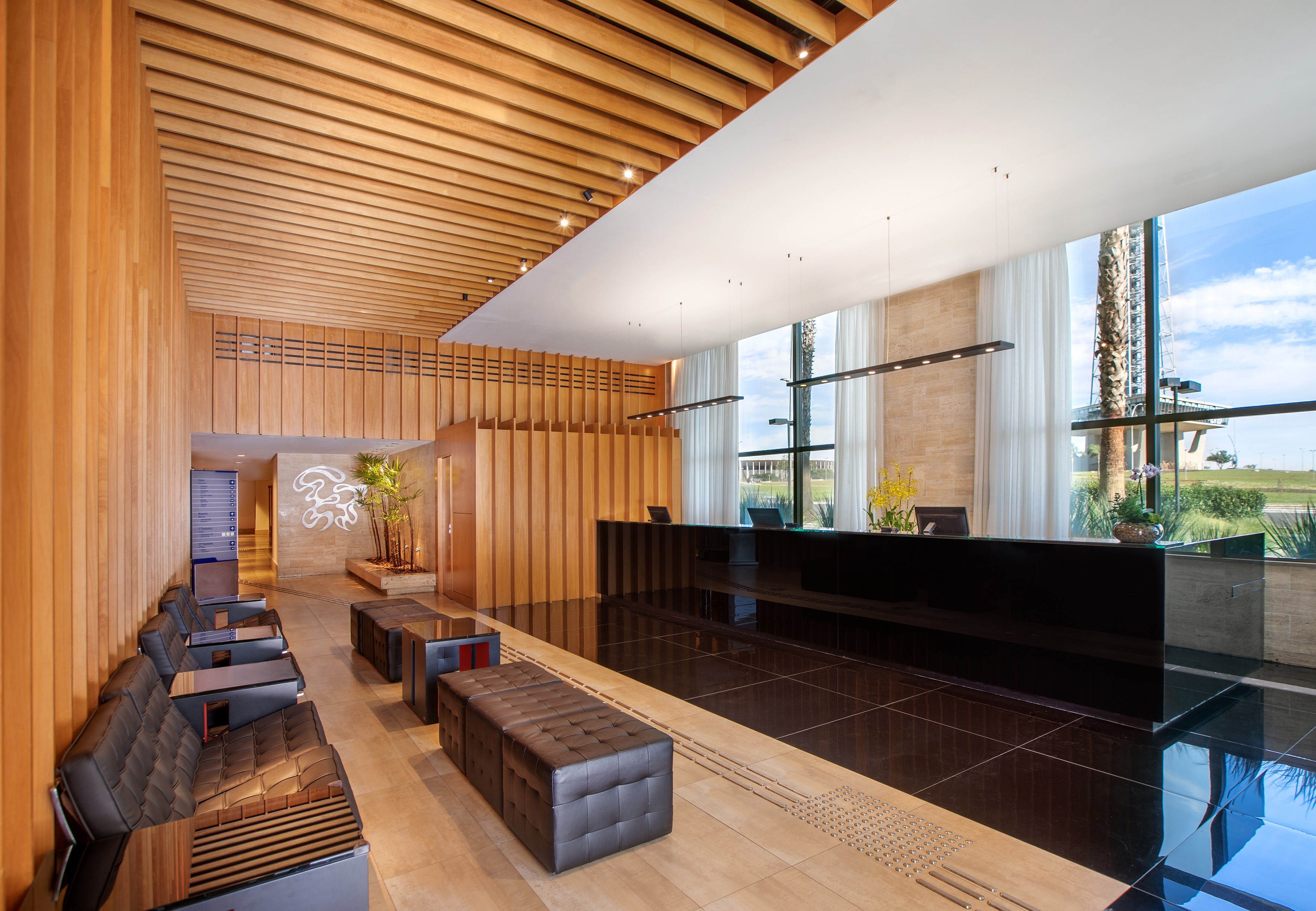 a lobby with a black counter and chairs