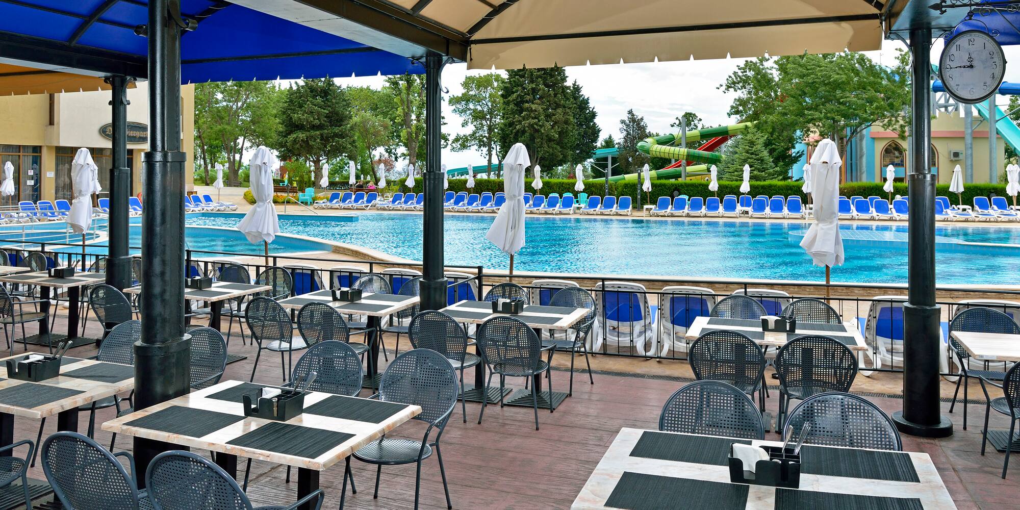 a pool with tables and chairs
