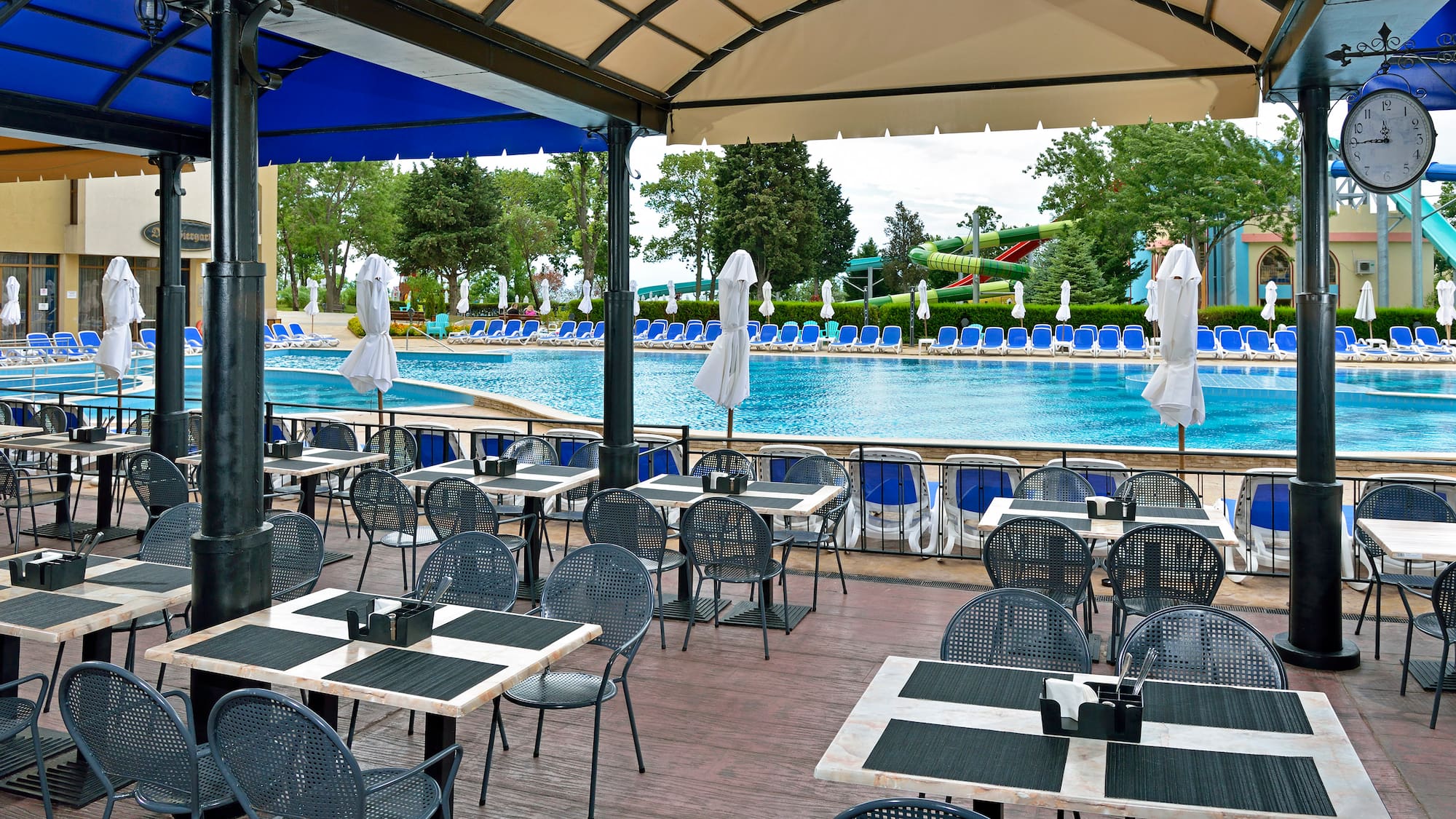 a pool with tables and chairs