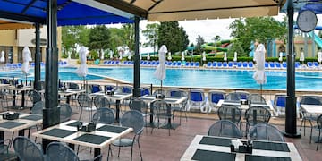 a pool with tables and chairs