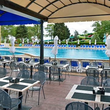 a pool with tables and chairs