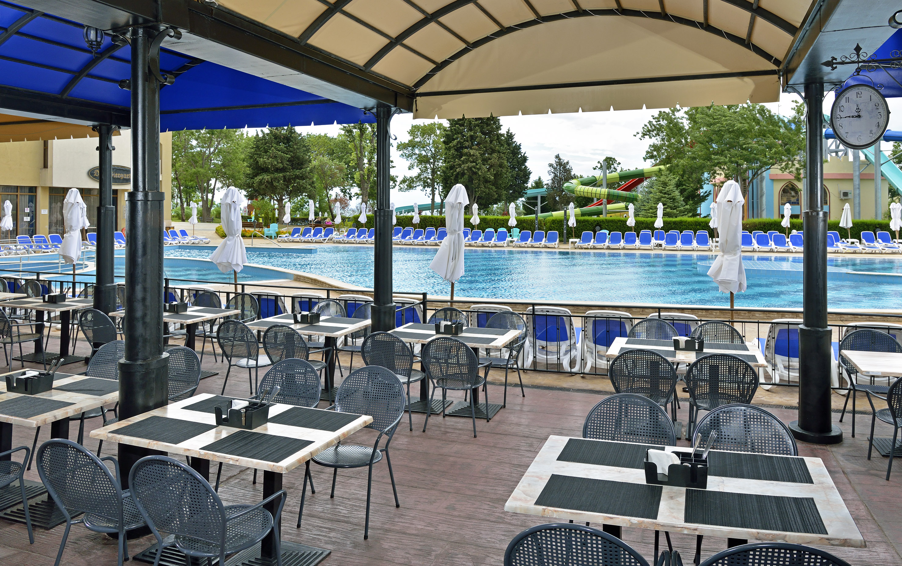 a pool with tables and chairs