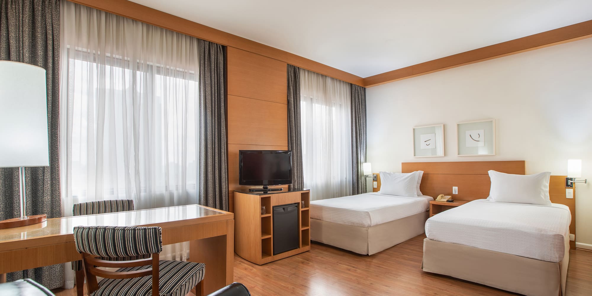 a room with two beds and a desk