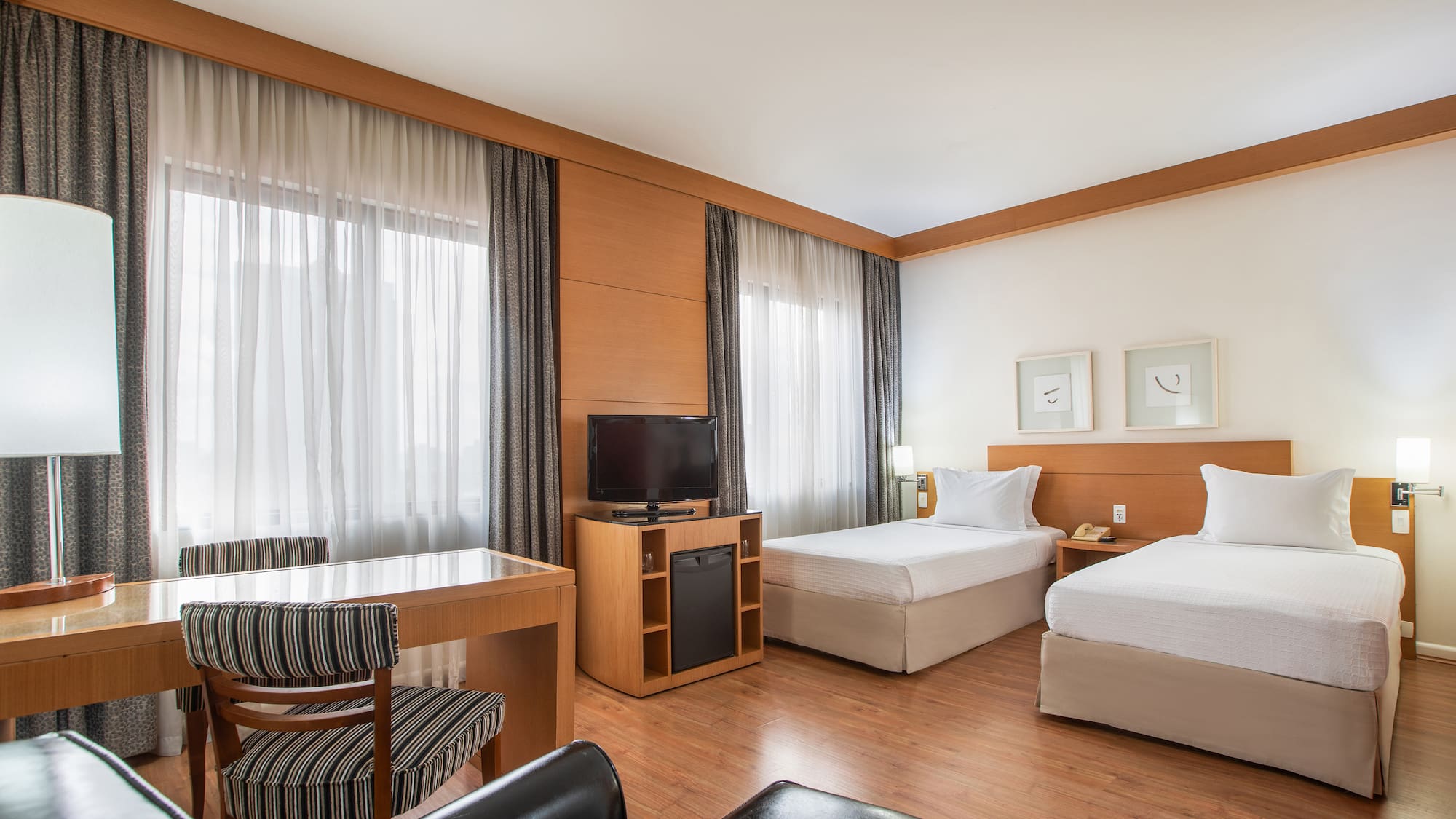 a room with two beds and a desk