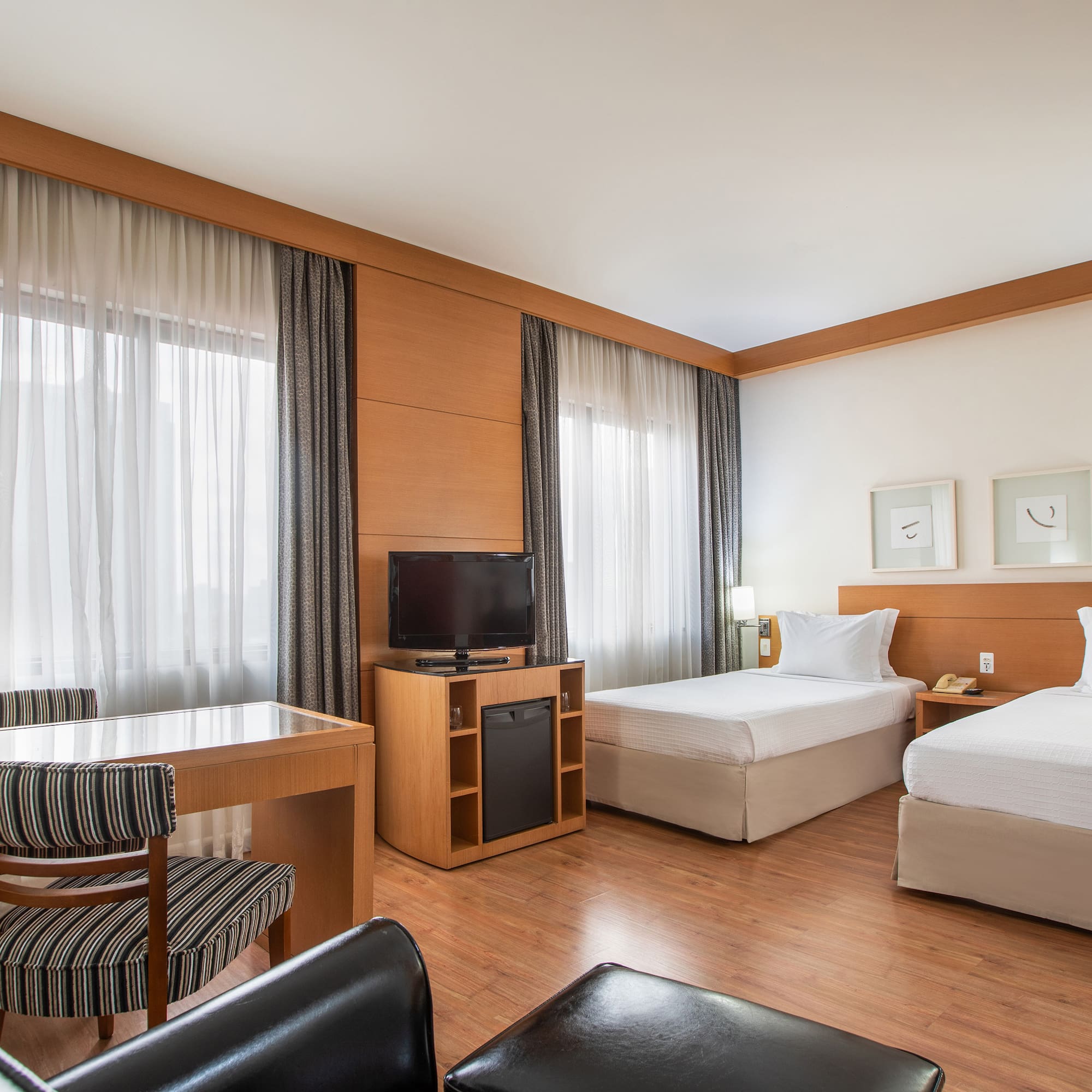 a room with two beds and a desk