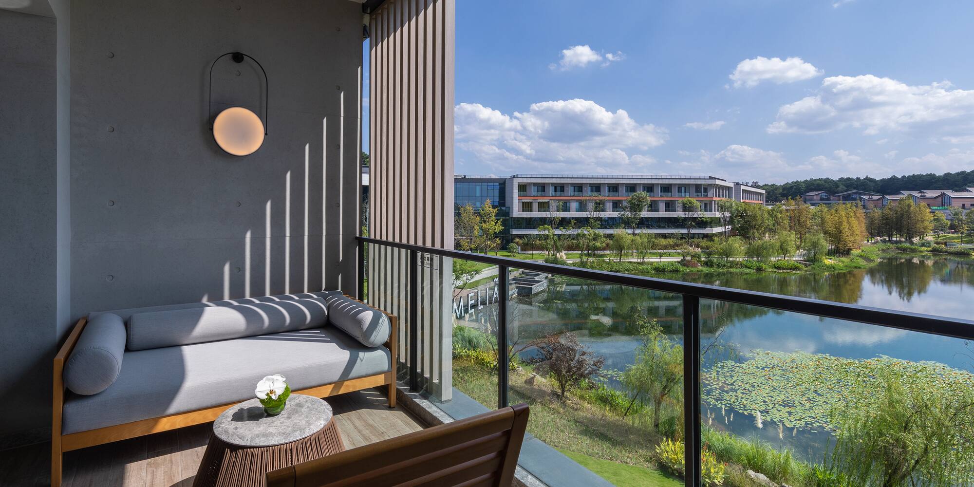 a balcony with a view of a river and a couch