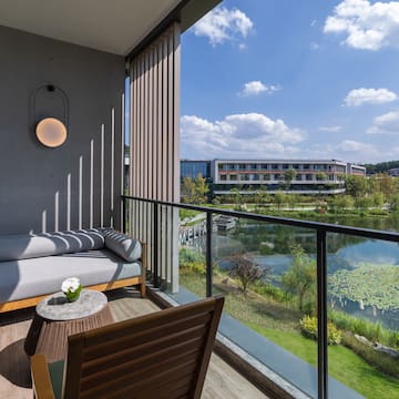 a balcony with a view of a river and a couch
