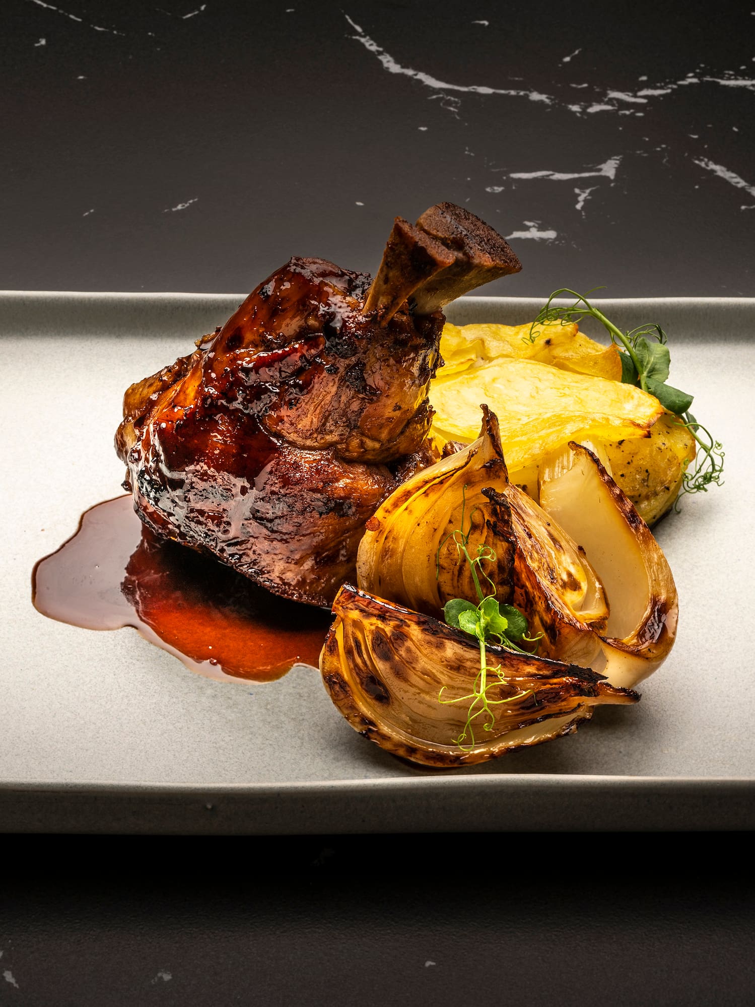 a plate of food on a black surface