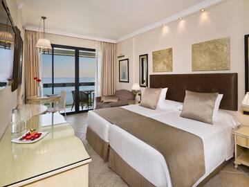 a room with a bed and a table and chairs
